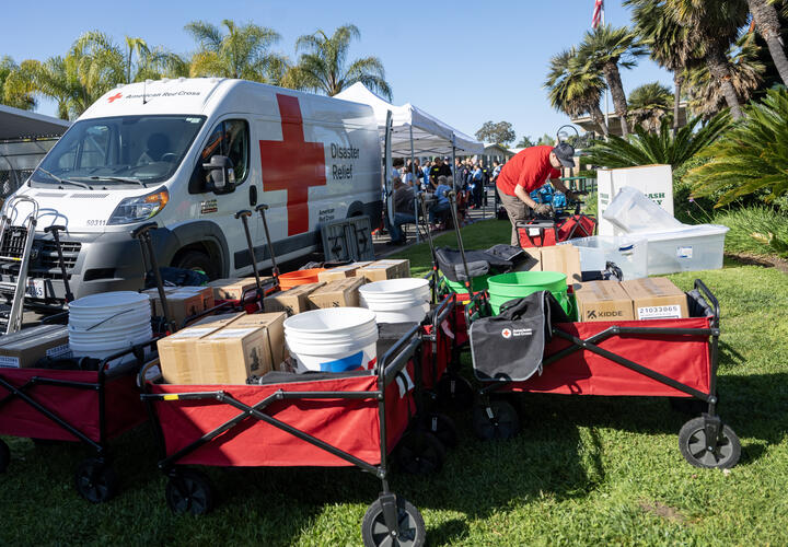 Fire alarm equipment in individual carts in front of an American Red Cross van
