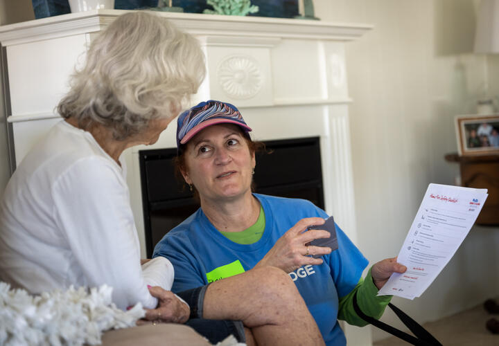 A female SDG&E employee provides emergency preparedness information to an oceanside resident