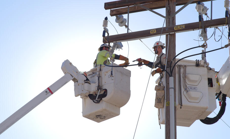 linemen conduct electrical operations from a bucket truck