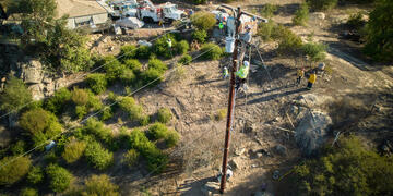 Linemen repairing a pole 