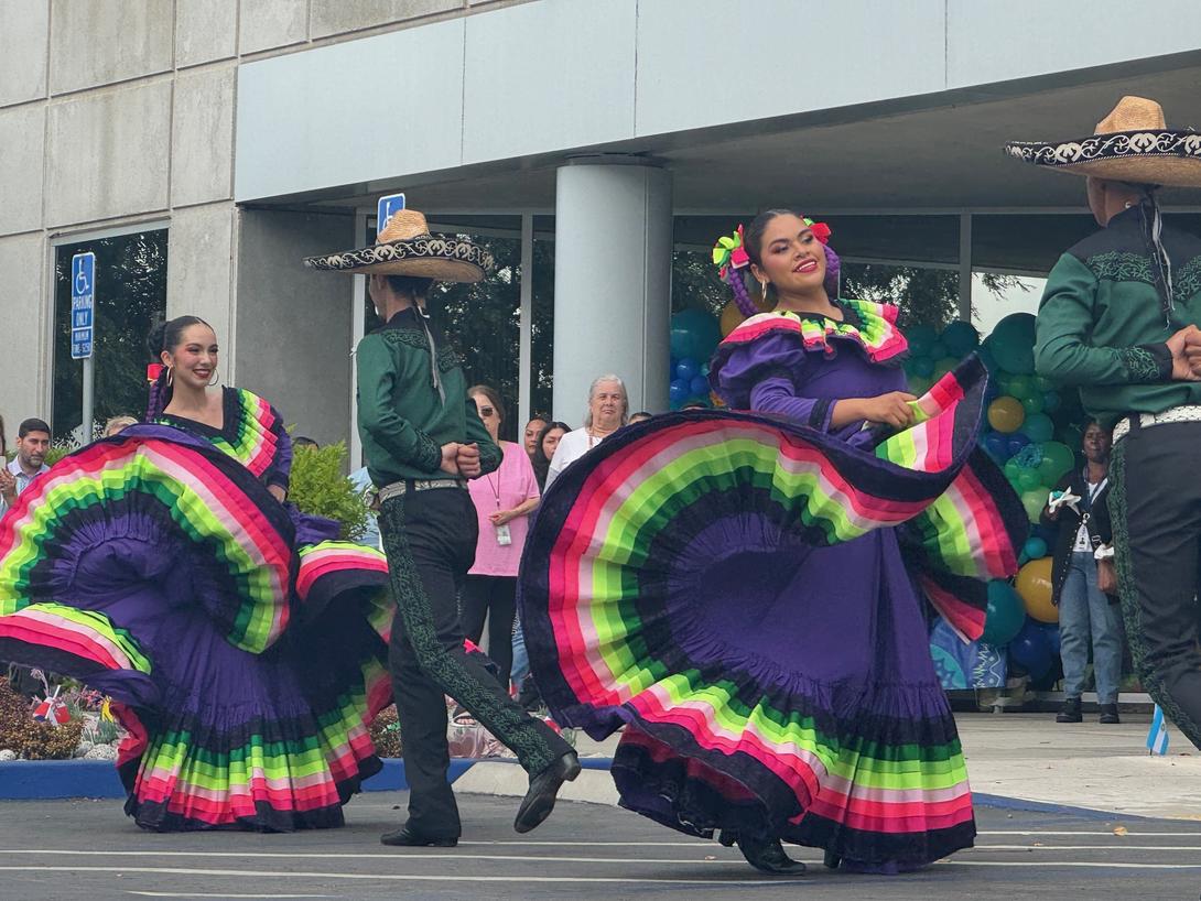 2 couples dancing baile folklorico, a traditional Mexican dance