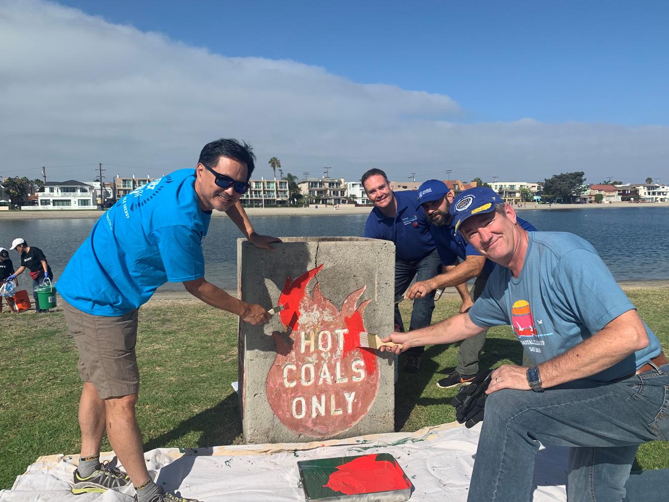 Team SDG&E/Sempra painting hot coal receptacle at Mission Bay