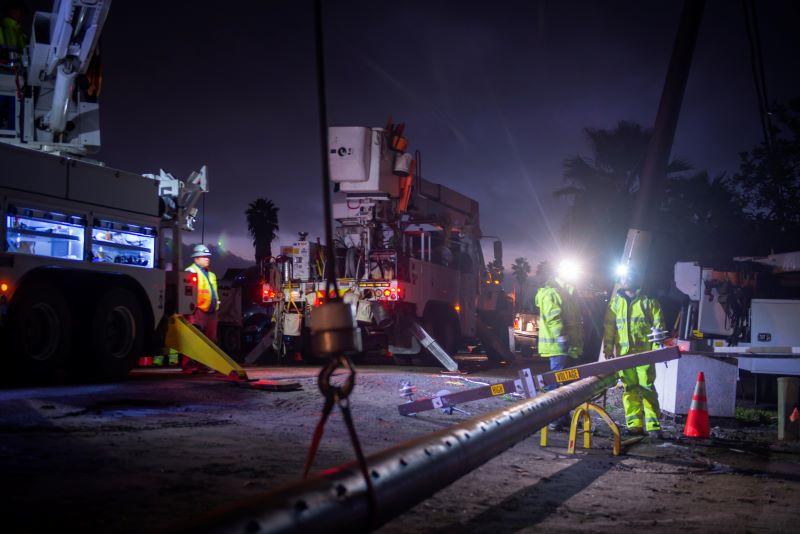 SDG&E crews replace a power pole at night