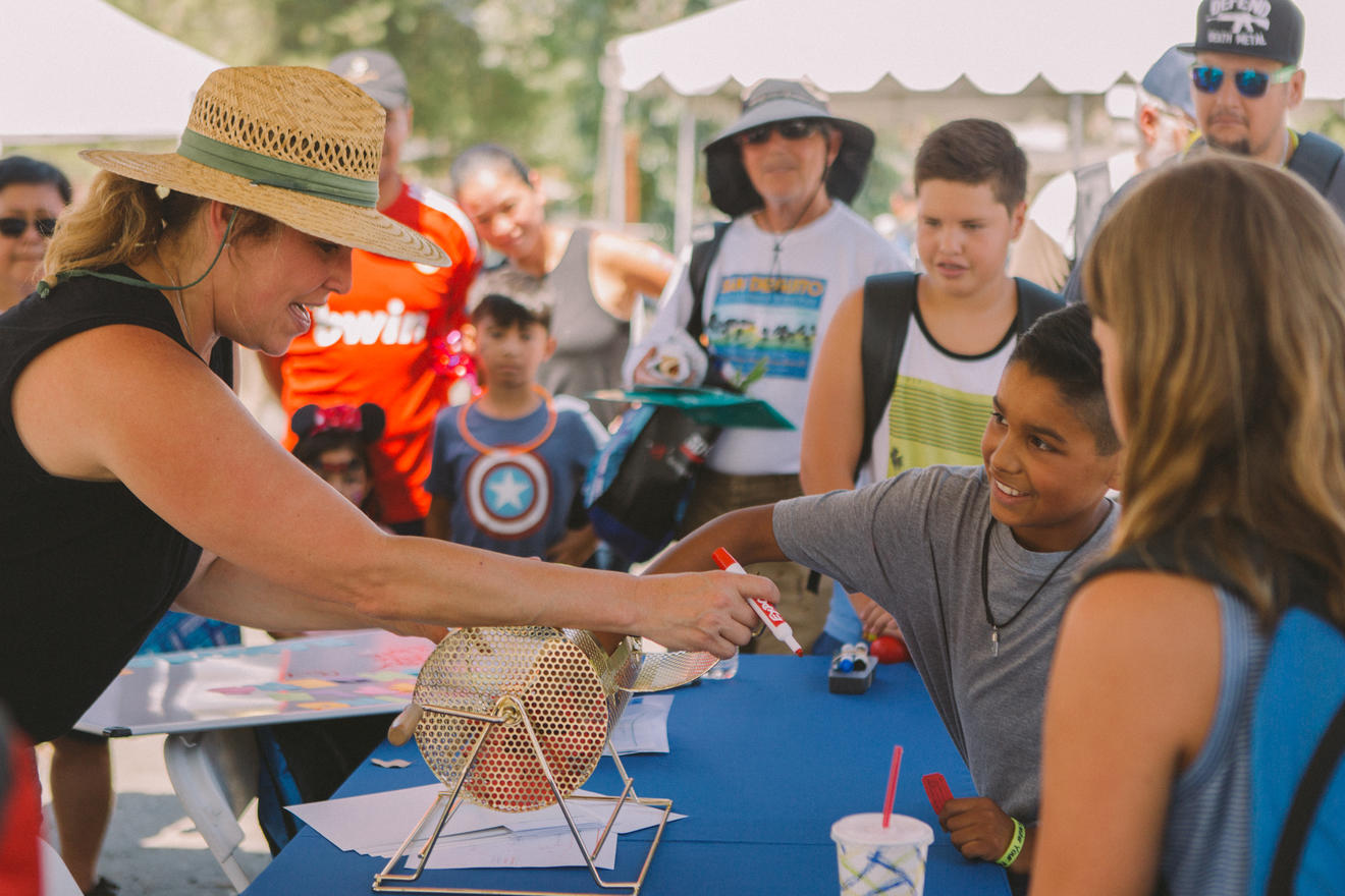 SDG&E Community Resilience Adviser, Robyn Brookshire (pictured left) helps children with raffle drawing 