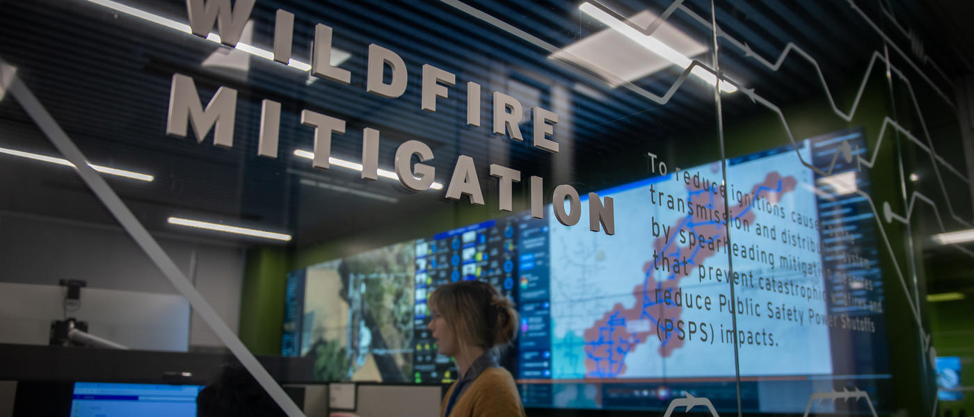 Image of female and male SDG&E employee working within the Wildfire Mitigation workspaces, within the Wildfire Climate and Resilience Center