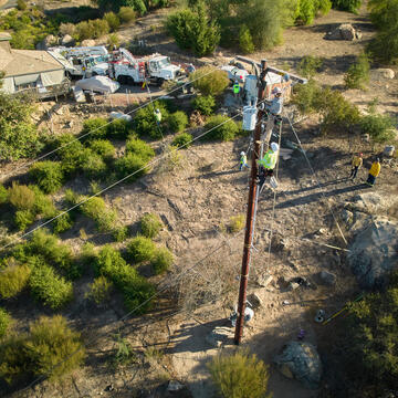 Linemen repairing a pole 