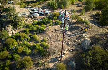 Linemen repairing a pole 