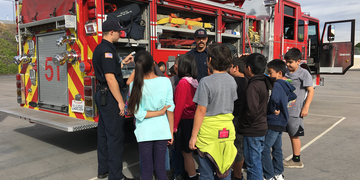 Picture of Fire Safe Kids Program - firefighter interacting with kids 