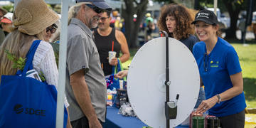 Image of female SDG&E employee smiling with a male participant at the Wildfire Safety Fair.