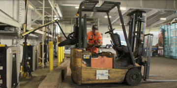 The Port's electric forklift being plugged into the new and efficient charging stations.