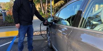   Tom Lunneberg charging his EV at MA Engineers, one of the Power Your Drive locations