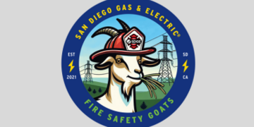 a graphic image of a sticker showing a sketch of a goat wearing a firefighter's hat, chewing on dry brush