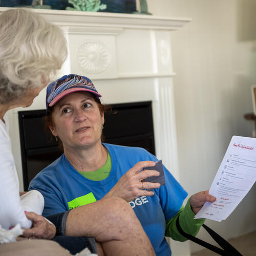 A female SDG&E employee provides emergency preparedness information to an oceanside resident